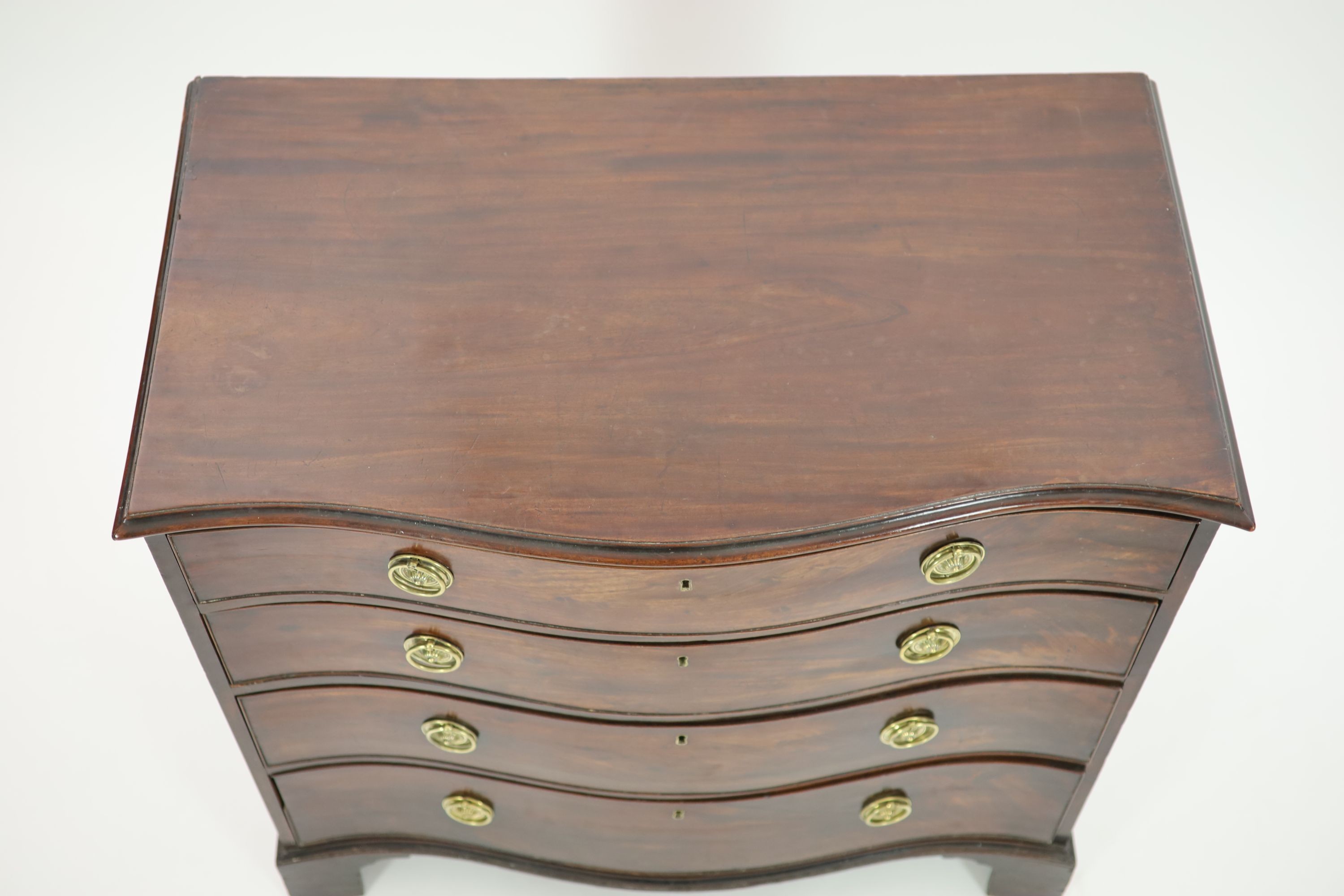 A George III mahogany serpentine chest of four graduated long drawers, W 95cm. D 55cm. H 90.5cm.